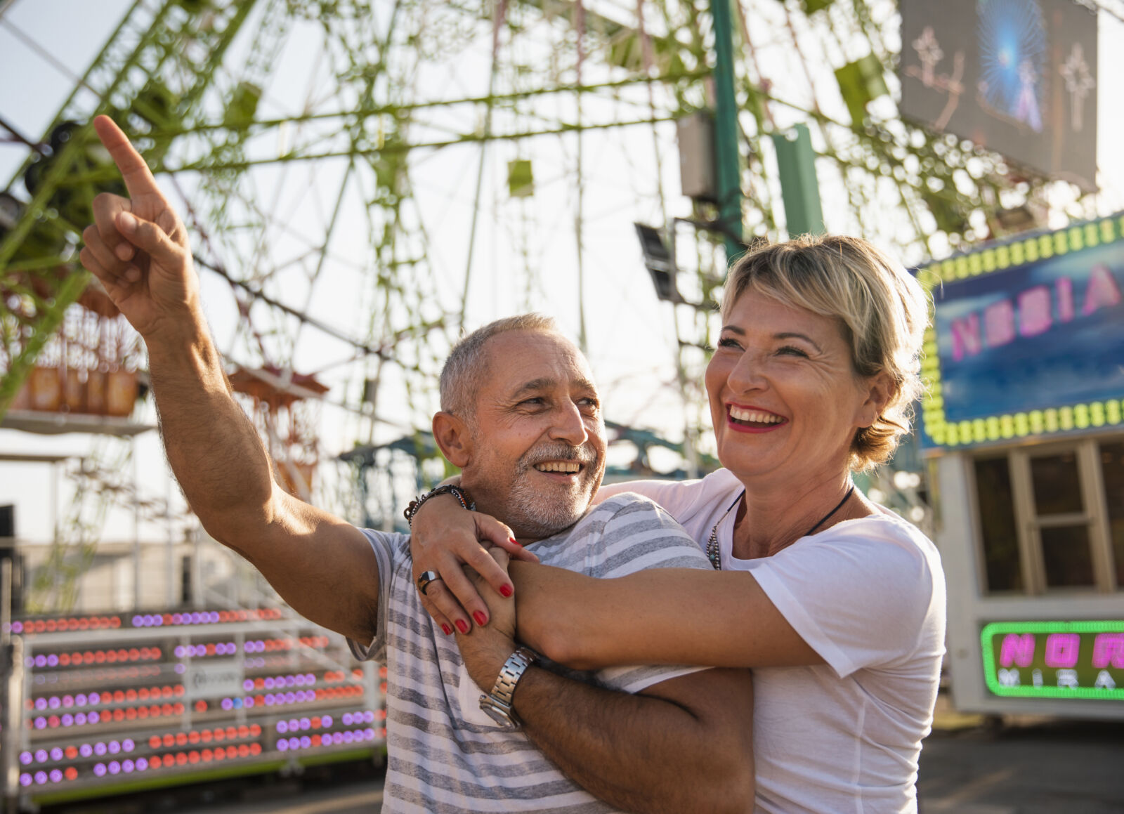 uomo e donna 50 anni sorridono in un parco giochi